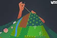 A hand sewing green lands